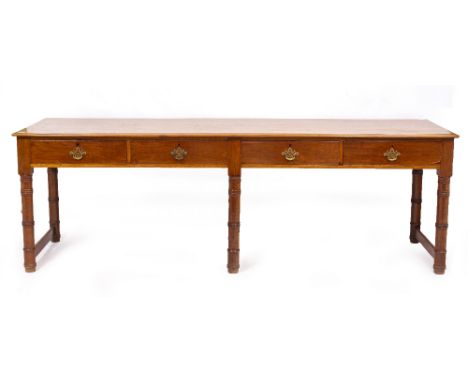 A MAHOGANY SIDE TABLE with four drawers and standing on ring turned legs, united by stretchers, 234cm long x 73cm deep x 80cm