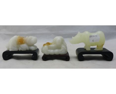 A Chinese carved white ''jade'' temple lion, together with a Chinese carved ''jade'' recumbent goat and a carved ''jade'' rhi