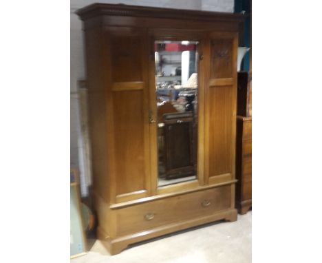 An Edwardian mahogany mirrored door wardrobe