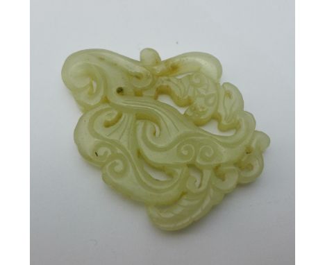 A Chinese carved and pierced jade pendant