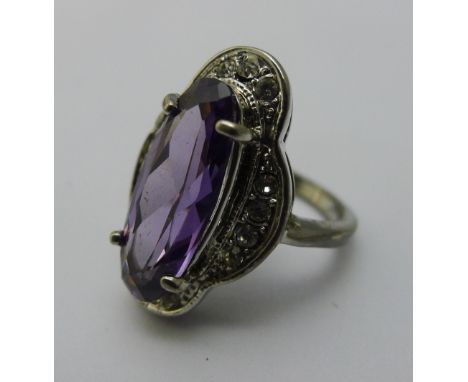 An unmarked white metal dress ring