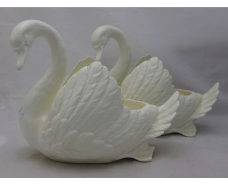 A pair of white ceramic swan planters