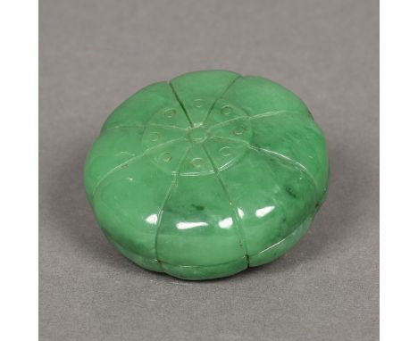 A Chinese carved green jade paste pot and coverOf flowerhead form.  6 cm diameter. 
