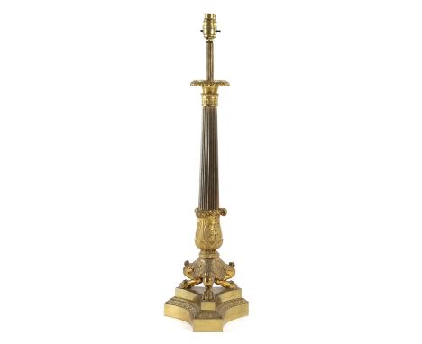 A GILT BRONZE TABLE LAMP IN EMPIRE STYLE, 19TH CENTURYwith a reeded stem above acanthus leaves on tripod monopodia supports a