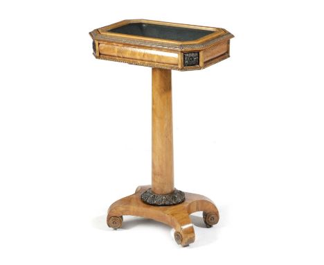 A BIEDERMEIER SATIN BIRCH BIJOUTERIE TABLEC.1830-40with a hinged glazed top with a push button opening mechanism, on brass ca