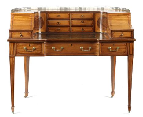 AN EDWARDIAN SATINWOOD CARLTON HOUSE DESKIN GEORGE III STYLE, EARLY 20TH CENTURYinlaid with ebonised stringing and fitted wit