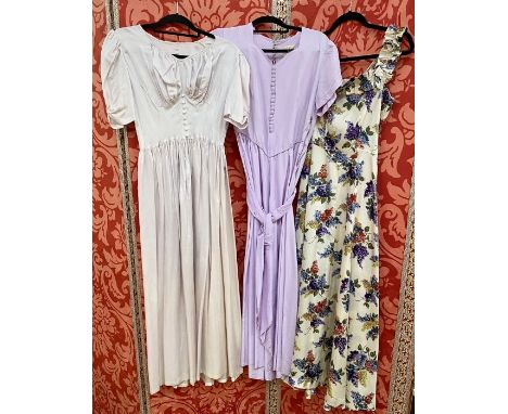 Seven various 1950's satin evening dresses to include a cream ground printed with lilacs, sleeveless, frilled detail to the n