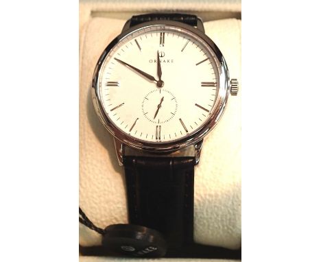 Boxed Ornake gents wristwatch stainless steel with white dial. P&amp;P Group 1 (£14+VAT for the first lot and £1+VAT for subs