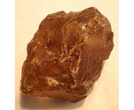 Large piece of unpolished amber coloured stone believed to be resinous amber, to weigh 58g. P&amp;P Group 1 (£14+VAT for the 