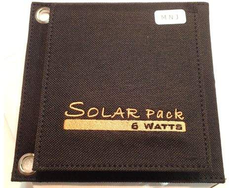 New old stock, 6 watt folding solar panel pack with one USB charging output. Integral part of case with magnetic catch and po