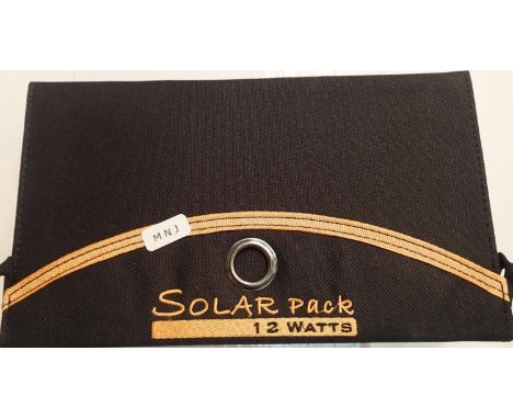 New old stock, 12 watt folding solar panel pack with two USB charging outputs. Integral part of case with magnetic catch and 