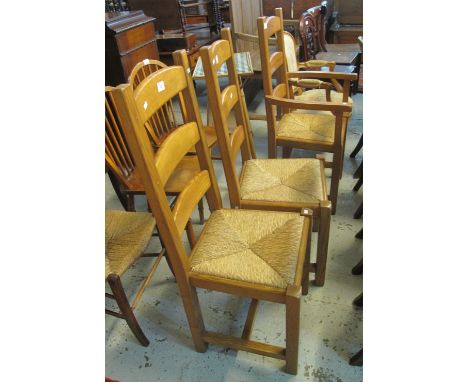 A set of three modern light oak bar back kitchen chairs with rush seats, (one carver, two chairs).  (B.P. 24% incl. VAT)