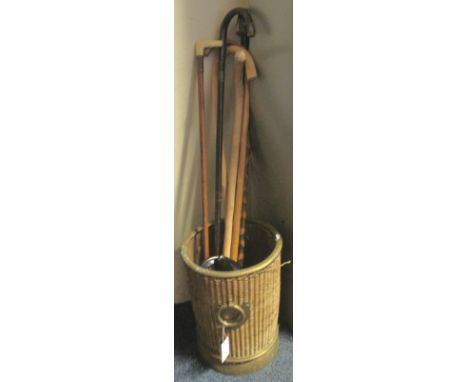 Wicker stick stand or litter bin, together with various walking sticks and canes, one having ivory handle and a pair of ebony