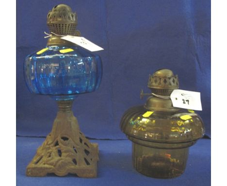 Early 20th Century single burner oil lamp with coloured glass reservoir and cast metal base, together with another oil lamp w