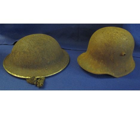 German First World War steel army helmet, together with a British type steel army helmet. (2) (B.P. 24% incl. VAT)