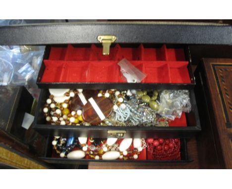 Green leather covered cantilever jewellery box containing a large collection of costume jewellery.(B.P. 24% incl. VAT)(Being 