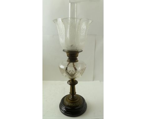 A LATE VICTORIAN OIL LAMP, with brass column, cut glass reservoir and an etched glass shade, complete with chimney to the top