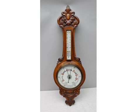 A LATE 19TH CENTURY CARVED OAK FRAMED WALL MOUNTABLE BANJO BAROMETER THERMOMETER, 90cm in length 