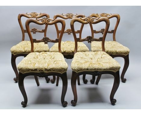 A SET OF FIVE LATE 19TH CENTURY ROSEWOOD FRAMED DINING CHAIRS, having carved scrolling backs and button upholstered seats, on