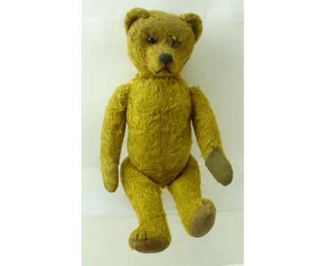 AN EARLY 20TH CENTURY TEDDY BEAR, golden mohair, with rotating head via tail mechanism, black wool work claws and nose, butto