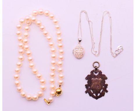 A 9 ct gold-mounted pearl necklace (boxed), a silver fob engraved to reverse 'Royal Empress, Tango 1951' and a silver locket 