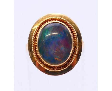 An 18 K gold opal ring.  Ring size N/O. 