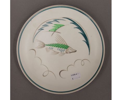 A Poole pottery plate with fish decoration. 21 cm diameter.
