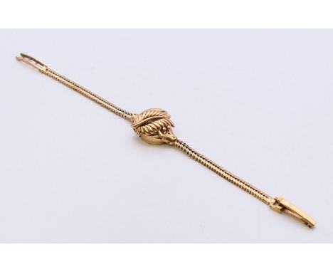 A 9 ct gold Rotary Maximus lady's wristwatch with hinged dial cover formed as a frond.  Dial 1.5 cm diameter. 16.4 grammes to