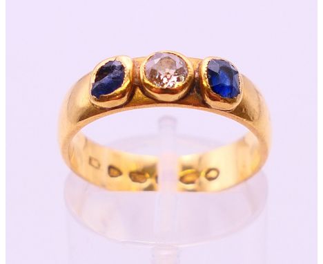 A 22 ct gold diamond and sapphire ring, hallmarked for London 1884.  Ring size N/O. 5.3 grammes.