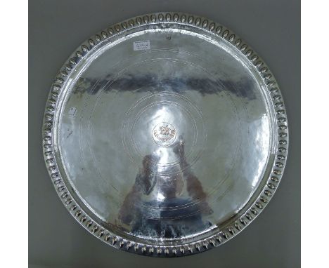 An early 19th century Anglo-Indian silver on copper circular tray with central crest and motto of the clan Pollock 'audacter 