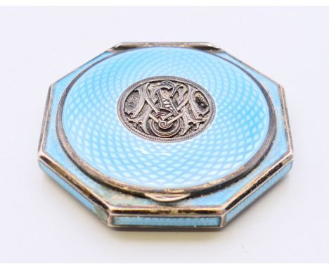 A silver and blue enamel compact.  6 cm diameter.