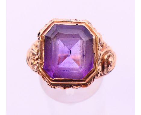 An unmarked gold and amethyst ring.  Ring size L/M.