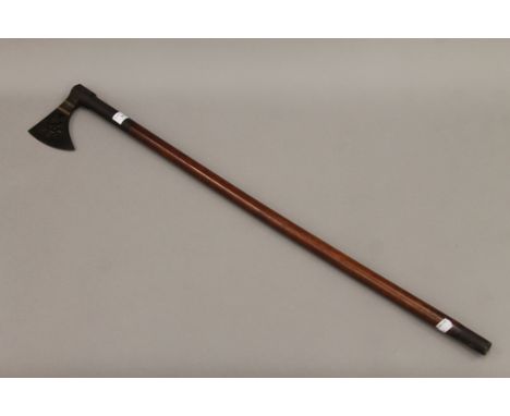 A fine 19th century Indo-Persian ceremonial axe with wooden shaft. 86 cm long.