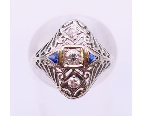 An 18 K white gold, diamond and sapphire ring.  Ring size O.