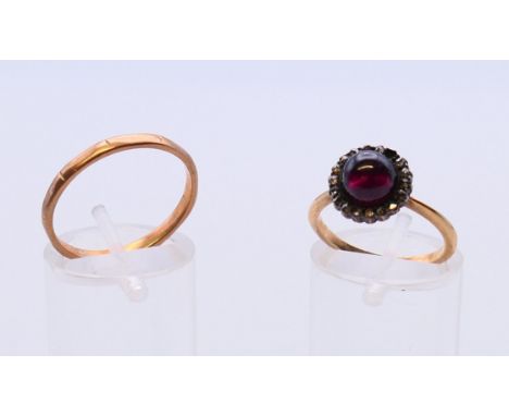A 9 ct gold band and an unmarked gold cabochon set ring.  Band ring size Q, cabochon set ring size K. 4.5 grammes total weigh
