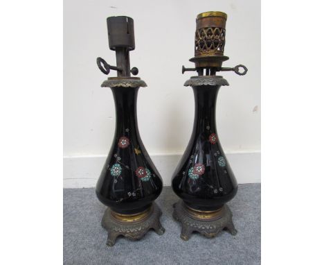 A pair of French black glass oil lamps with enamelled foliate design on a brass footed base.    Collector's Electrical Item: 