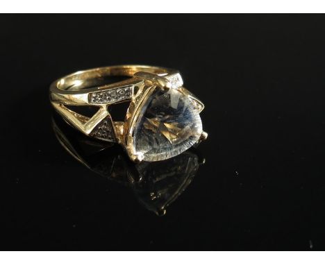 A 9ct gold ring set with trilogy cut lavender quartz and diamonds