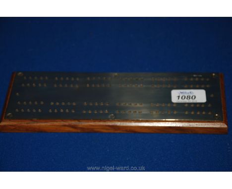 An early 20th c. oak and heavy gauge brass Cribbage Board, 9 1/2" long.