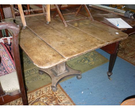 An early 19th c. rectangular Oak five plank top Breakfast Table having a tapering square central pillar support with platform