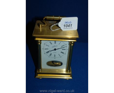 A modern brass eight day Carriage style mantle Clock with striker and pendulum.