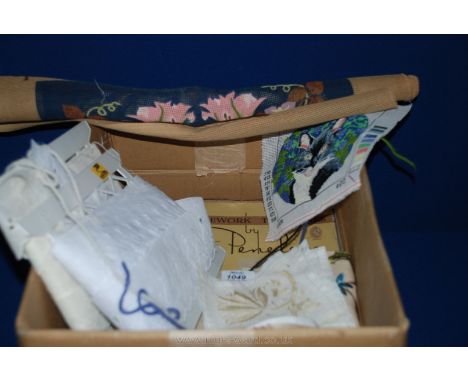 A box of tapestry's, patterns and materials, a rug making tool, etc.