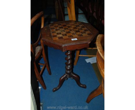 An octagonal Walnut and Mahogany chess/draughts Table having twist support and three splay feet, some losses to frieze, 18" d