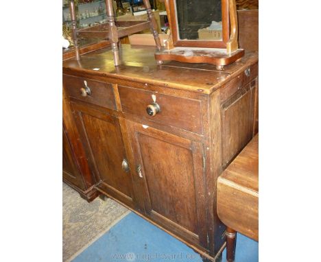 A 19th c. Oak double doored Cupboard having a pair of drawers over with turned handles and shield-shaped lock escutcheons, 43