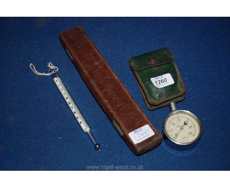 A vintage cheese churn Thermometer fahrenheit in a lined leather box together with a vintage chrome pressure Gauge lb per squ