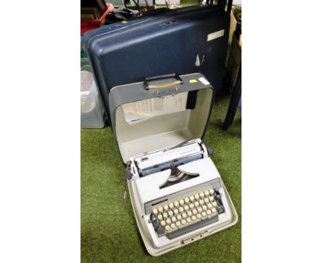 A cased Adler typewriter, and a suitcase. 