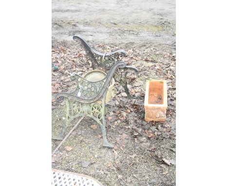 TWO CAST IRON BENCH ENDS, a urn and a terracotta planter, etc (5)