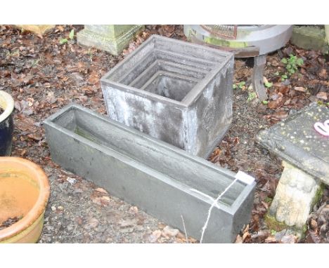 A NEST OF FOUR GRADUATED LEAD LOOK MODERN PATIO PLANTERS, and a long rectangular patio planter