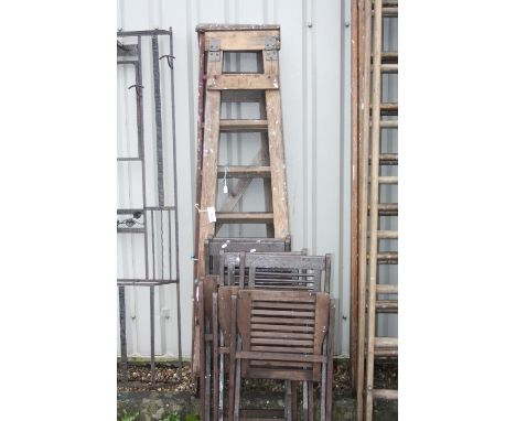 FOUR WOODEN FOLDING GARDEN CHAIRS, and two sets of wooden step ladders, 186cm high (6)