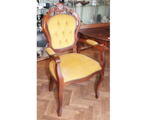Upholstered button back elobow chair with carved back 