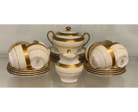 A Minton bone china 'Buckingham' pattern part tea service, decorated with gilding to border, comprising a lidded sugar bowl, 